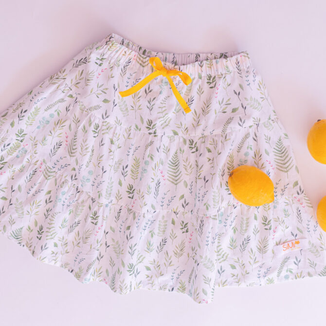 flatlay of white skirt with lemons