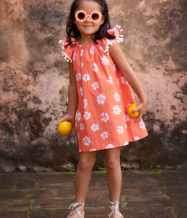 Girl in orange dress, smiling