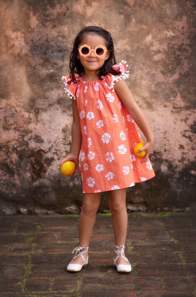 Girl in orange dress, smiling