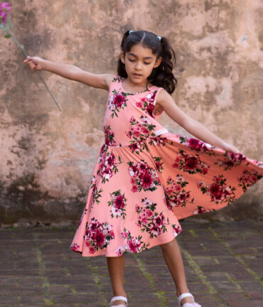 Girl twirling in her salmon color dress