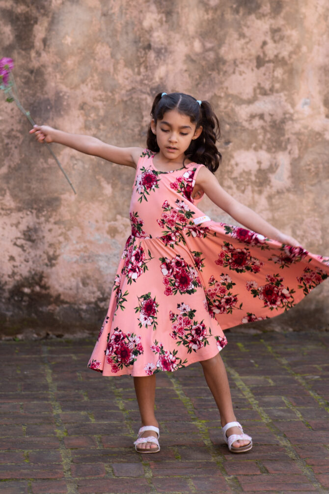 Girl twirling in her salmon color dress