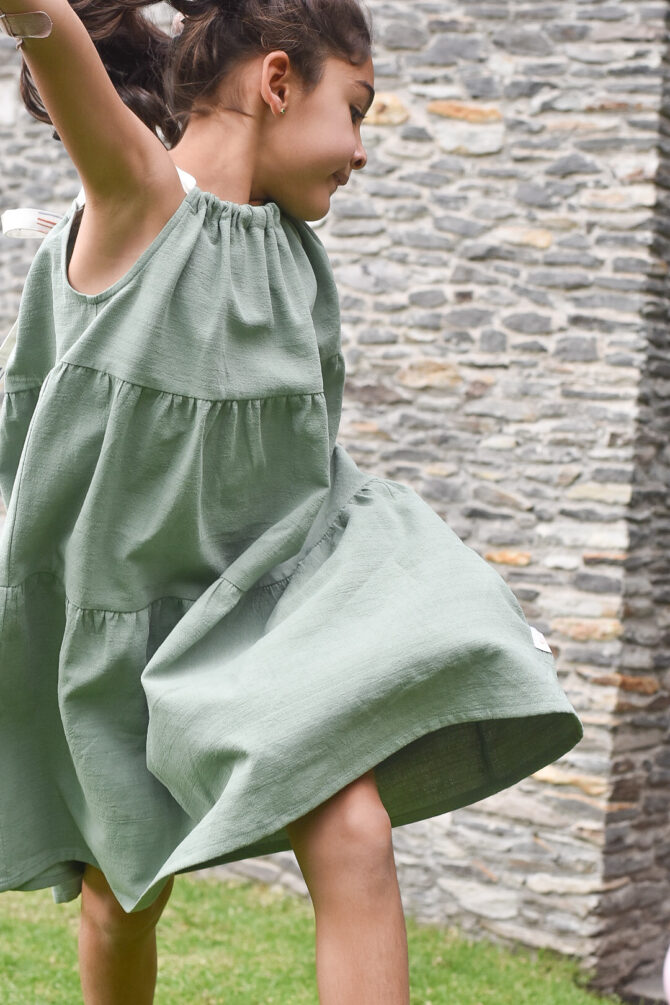 Girl in green dress jumping