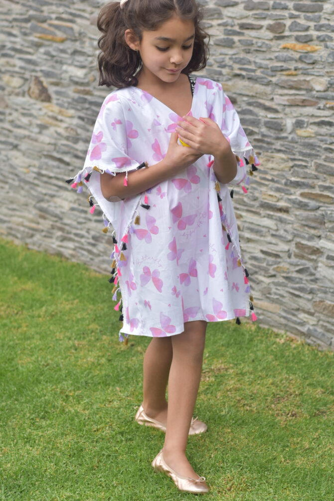 girl in kaftan playing with ball