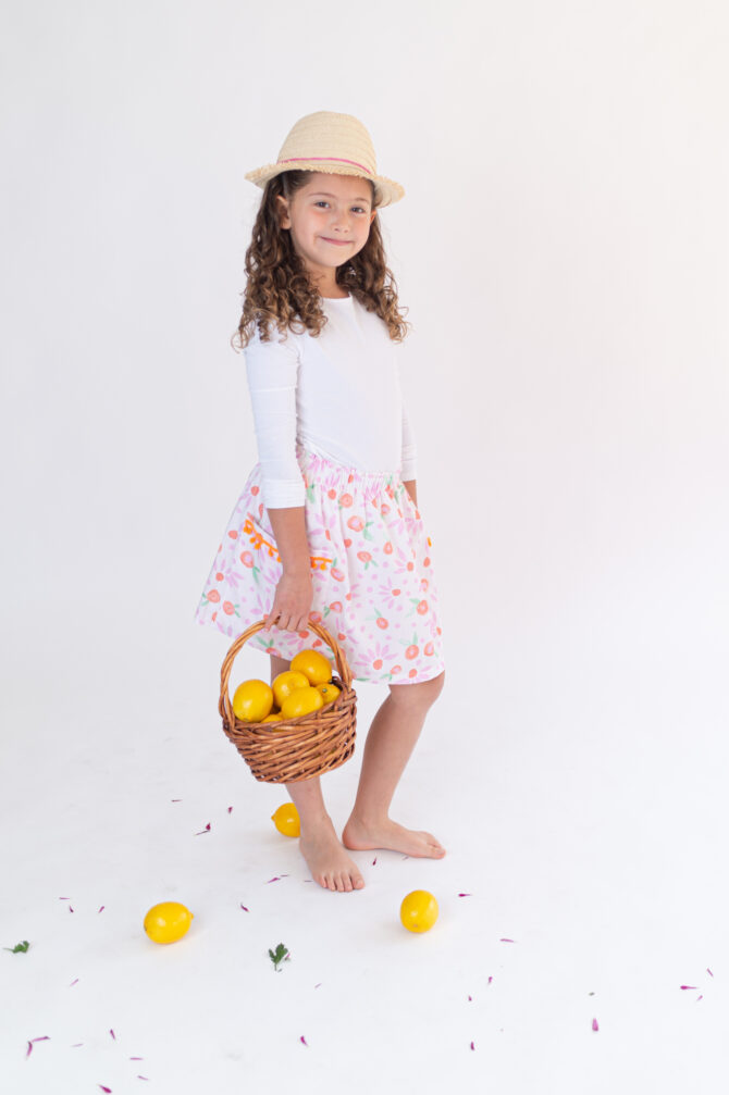 Girl with skirt holding a basket