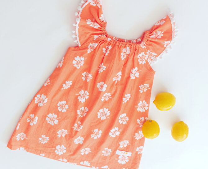 Flatlay of orange dress