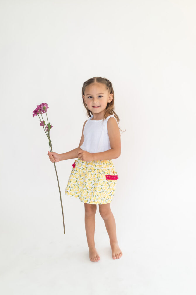 Girl with skirt holding a flower