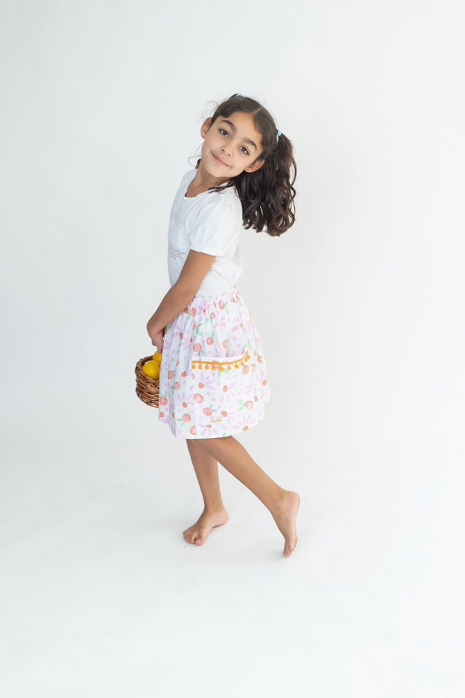 Girl in skirt holding a basket